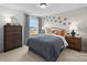 Inviting bedroom featuring warm colors, a window view, and decorative paw prints at 889 Regulus Ct, York, SC 29745