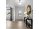 Bright foyer featuring wood-look flooring, modern light fixture, console table with mirror, and paneled accent walls at 889 Regulus Ct, York, SC 29745