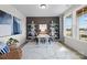 Cozy home office featuring an accent wall, stylish decor, white bookshelves, a modern light fixture, and natural light at 889 Regulus Ct, York, SC 29745