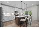 Modern kitchen featuring white cabinetry, a large island with pendant lighting, and stainless steel appliances at 889 Regulus Ct, York, SC 29745