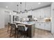 Modern kitchen featuring white cabinetry, a large island with pendant lighting, and stainless steel appliances at 889 Regulus Ct, York, SC 29745