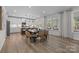 Bright, open kitchen featuring a large island, modern appliances, and an adjacent dining area with seating at 889 Regulus Ct, York, SC 29745