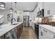 Modern kitchen with stainless steel appliances, white cabinets, and a kitchen island for extra counter space at 889 Regulus Ct, York, SC 29745