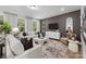 Spacious living room with a comfortable sofa, accent pillows, modern decor, and a large window with natural light at 889 Regulus Ct, York, SC 29745