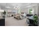 Spacious primary bedroom featuring a sitting area, tray ceilings, and ample natural light from large windows at 889 Regulus Ct, York, SC 29745