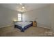 Comfortable bedroom with carpet, ceiling fan, window with natural light and a minimalist decor at 9031 Pembroke Ct, Indian Land, SC 29707