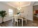 Bright dining room featuring tray ceiling and a wooden dining table at 9031 Pembroke Ct, Indian Land, SC 29707