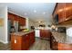 Spacious kitchen with an island, stainless steel fridge, and dark wooden cabinetry at 9031 Pembroke Ct, Indian Land, SC 29707