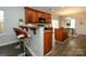 Well-equipped kitchen featuring wooden cabinetry, a breakfast bar, and granite countertops at 9031 Pembroke Ct, Indian Land, SC 29707