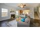 Inviting living room featuring a fireplace, plush seating, and seamless flow into the kitchen at 9031 Pembroke Ct, Indian Land, SC 29707