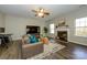 Comfortable living room with a fireplace, large TV, and neutral tones at 9031 Pembroke Ct, Indian Land, SC 29707