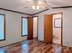 Wood-look floors are displayed in this bedroom with two windows at 9404 Mini Ranch Rd, Waxhaw, NC 28173