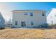 The spacious backyard features a well-maintained lawn and a concrete patio with a sliding glass door at 10036 Paper Birch Dr, Charlotte, NC 28215