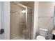 Tiled bathroom with glass shower doors and a view of the toilet at 10036 Paper Birch Dr, Charlotte, NC 28215