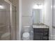 Modern bathroom featuring a glass-enclosed shower, toilet, and vanity with granite countertop at 10036 Paper Birch Dr, Charlotte, NC 28215