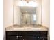 Granite countertop with double sinks and a view of a glass-enclosed shower at 10036 Paper Birch Dr, Charlotte, NC 28215