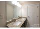 Beautiful bathroom showcasing a double vanity with granite countertop and contemporary fixtures at 10036 Paper Birch Dr, Charlotte, NC 28215