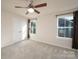 Bright and airy bedroom with neutral carpet and two windows at 10036 Paper Birch Dr, Charlotte, NC 28215