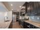Gourmet kitchen with granite countertops, stainless steel appliances, dark wood cabinets, and tiled backsplash at 10036 Paper Birch Dr, Charlotte, NC 28215