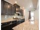 Kitchen featuring granite countertops, stainless steel appliances, dark wood cabinets, and a gas range at 10036 Paper Birch Dr, Charlotte, NC 28215
