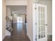 Open-concept living room with dark wood floors, neutral walls, and sliding glass doors to the backyard at 10036 Paper Birch Dr, Charlotte, NC 28215