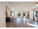 Spacious living room featuring dark wood floors, ample lighting, and an open layout at 10036 Paper Birch Dr, Charlotte, NC 28215
