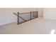 Open loft area featuring neutral carpeting and wrought iron railing at 10036 Paper Birch Dr, Charlotte, NC 28215