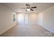 Spacious main bedroom with carpet, a ceiling fan, and two doors at 10036 Paper Birch Dr, Charlotte, NC 28215