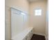Bright mudroom featuring a built-in bench with storage and coat hooks for added convenience at 10036 Paper Birch Dr, Charlotte, NC 28215