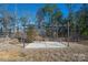 A pergola sits on a concrete slab, surrounded by brown grass at 10036 Paper Birch Dr, Charlotte, NC 28215