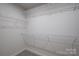 Empty walk-in closet with multiple wire shelves at 10036 Paper Birch Dr, Charlotte, NC 28215