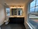 Modern bathroom with double vanity, sleek black cabinets, and a large window for natural light at 107 Spring View Ln, Statesville, NC 28677
