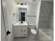 Bathroom with tiled floors and walls, a vanity with a sink, a toilet, and a bathtub at 107 Spring View Ln, Statesville, NC 28677