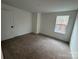 A carpeted bedroom with one window and white walls at 107 Spring View Ln, Statesville, NC 28677
