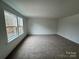Spacious bedroom featuring large windows offering plenty of natural light and neutral carpet at 107 Spring View Ln, Statesville, NC 28677
