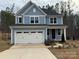 Charming two-story home with light blue siding and a white two-car garage at 107 Spring View Ln, Statesville, NC 28677
