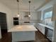 Modern kitchen with a center island, stainless steel appliances, and white cabinets at 107 Spring View Ln, Statesville, NC 28677
