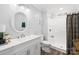 Bright bathroom featuring white cabinets, a white vanity, a tiled shower and modern fixtures at 1075 Wellman St, Gastonia, NC 28054