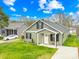 Charming home featuring green siding, black shutters, a well-manicured lawn and a cozy front porch at 1075 Wellman St, Gastonia, NC 28054