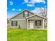 Charming two-story home featuring a welcoming front porch and a lush green lawn at 1075 Wellman St, Gastonia, NC 28054