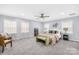 Spacious main bedroom featuring soft gray walls, carpet, a ceiling fan and plenty of natural light at 1075 Wellman St, Gastonia, NC 28054