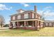 Charming brick home with a welcoming porch, mature trees, and a well-manicured lawn at 111 Bethpage Rd, Kannapolis, NC 28081