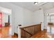 Bright hallway features hardwood floors, wood railing, and access to adjacent rooms at 111 Bethpage Rd, Kannapolis, NC 28081