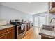 Kitchen featuring updated appliances, wood cabinets, granite counters, and access to the backyard at 111 Bethpage Rd, Kannapolis, NC 28081