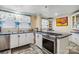 Kitchen featuring an island cooktop with stainless steel appliances and white cabinets with unique patterned tile counters at 111 Bethpage Rd, Kannapolis, NC 28081