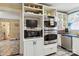 Bright kitchen featuring stainless steel appliances, white cabinetry, built-in shelving and unique tile flooring at 111 Bethpage Rd, Kannapolis, NC 28081