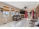 Comfortable living room featuring large windows, a fireplace, a ceiling fan, and ample seating at 111 Bethpage Rd, Kannapolis, NC 28081