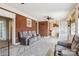 Spacious living room featuring a brick wall, ceiling fan, unique flooring, and comfortable seating at 111 Bethpage Rd, Kannapolis, NC 28081