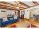 Open living room with hardwood floors, wood beams, and a seamless flow to the dining area at 111 Bethpage Rd, Kannapolis, NC 28081
