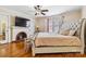 Spacious bedroom with hardwood floors, a ceiling fan, and a decorative fireplace at 111 Bethpage Rd, Kannapolis, NC 28081